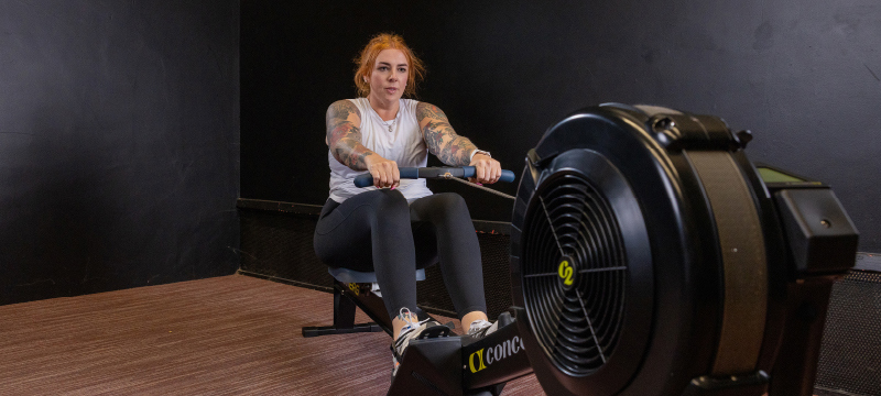 female exercising on a rowing machine