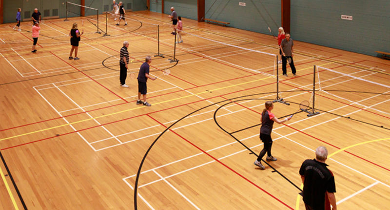 Badminton players in an indoor court