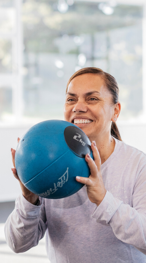Side image women with medicine ball