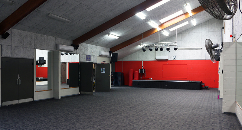 Grey carpeted floor, wall fans and mirrors in the dance studio at East Coast Bays Leisure Centre.