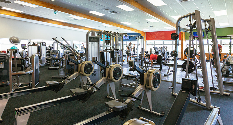 image of a fitness centre with rowing machinges and weight machines