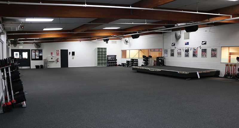 photo of room with stage and group fitness weights on the side