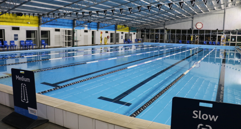 photo of pool with lane ropes and flags