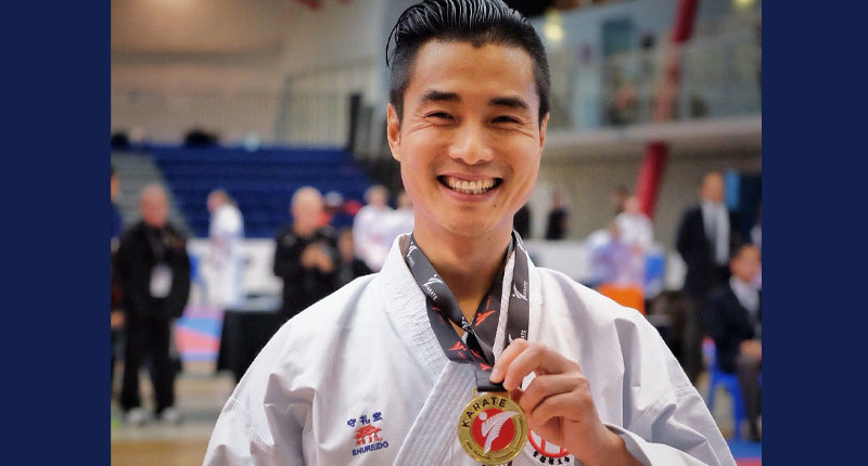 Ricky Liu wearing a kimono and holding his medal in November 2019