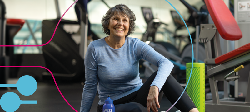 female sitting in gym smiling